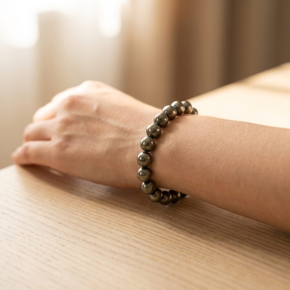 Certified Pyrite Bracelet worn on wrist lifestyle photo on wood surface with natural light