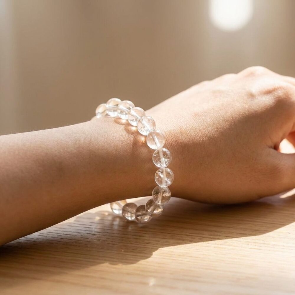 Sphatik Clear Quartz Bracelet worn on wrist lifestyle photo on wood surface with natural light