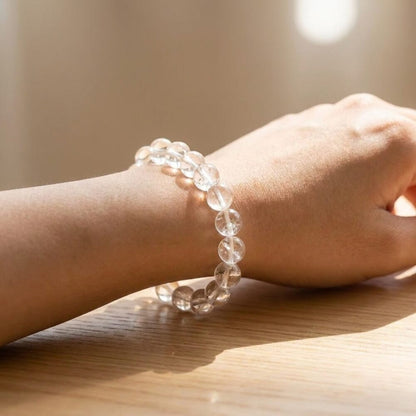 Sphatik Clear Quartz Bracelet worn on wrist lifestyle photo on wood surface with natural light