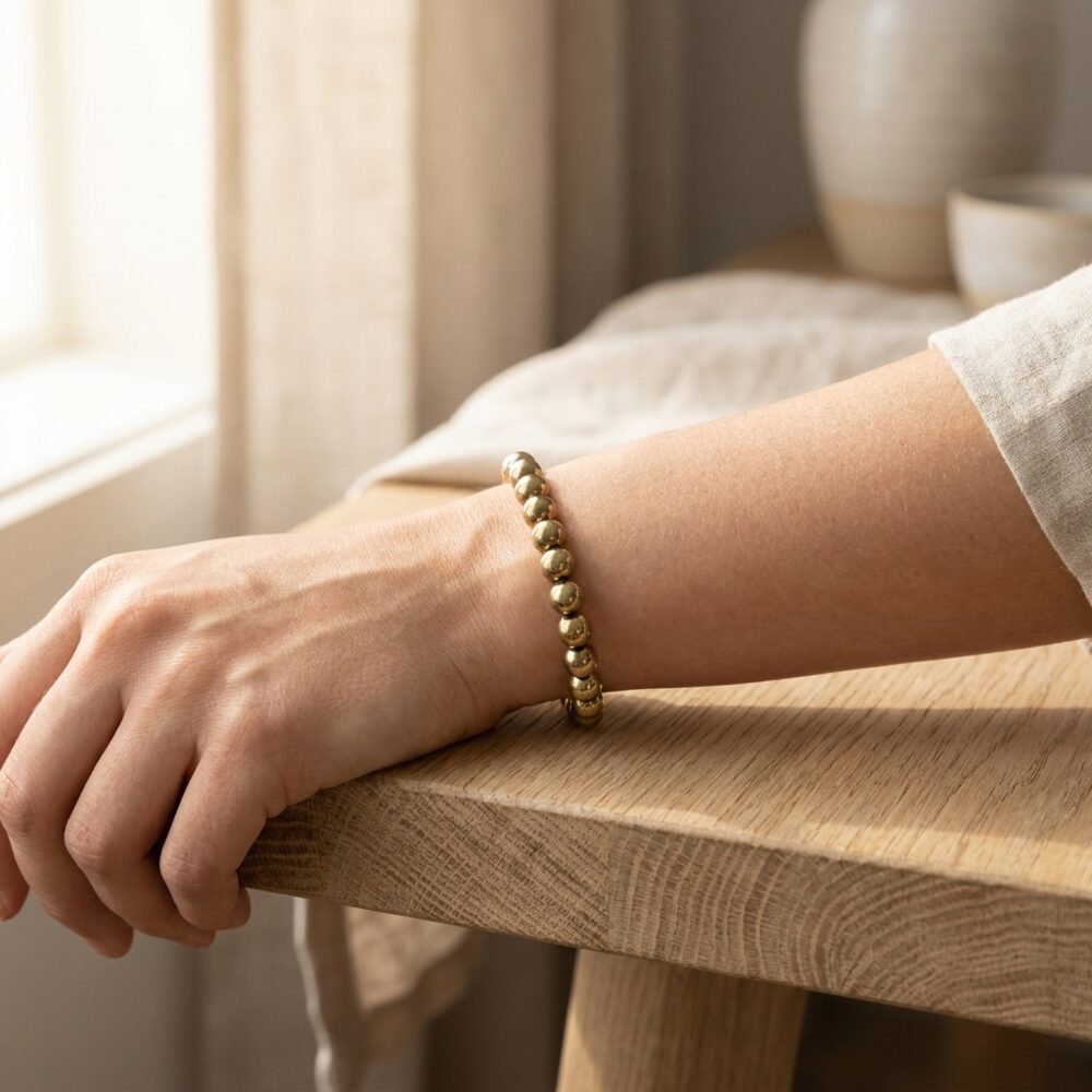 Golden Pyrite Bracelet worn on wrist lifestyle photo on wood surface with natural light