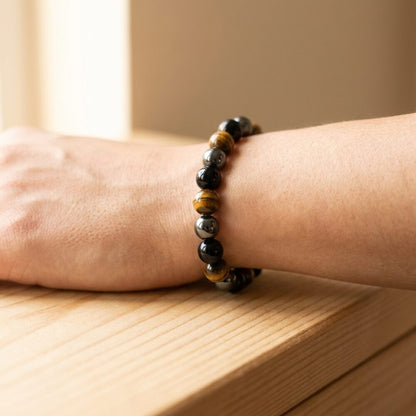 Triple Protection Bracelet worn on wrist lifestyle photo on wood surface with natural light