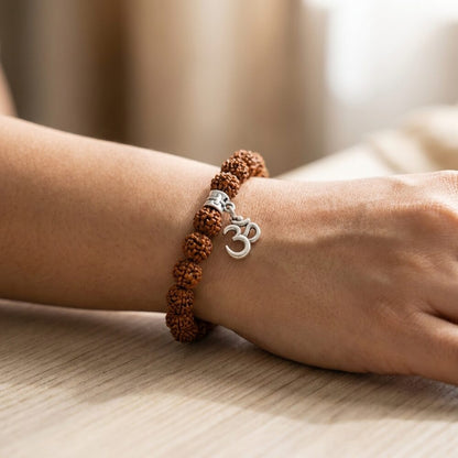 5 Mukhi Rudraksh Bracelet with Om worn on wrist lifestyle photo on wood surface with natural light