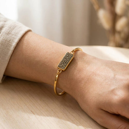 Pyrite Druzy gold-plated wealth bangle for women worn on wrist lifestyle photo on wood surface with natural light