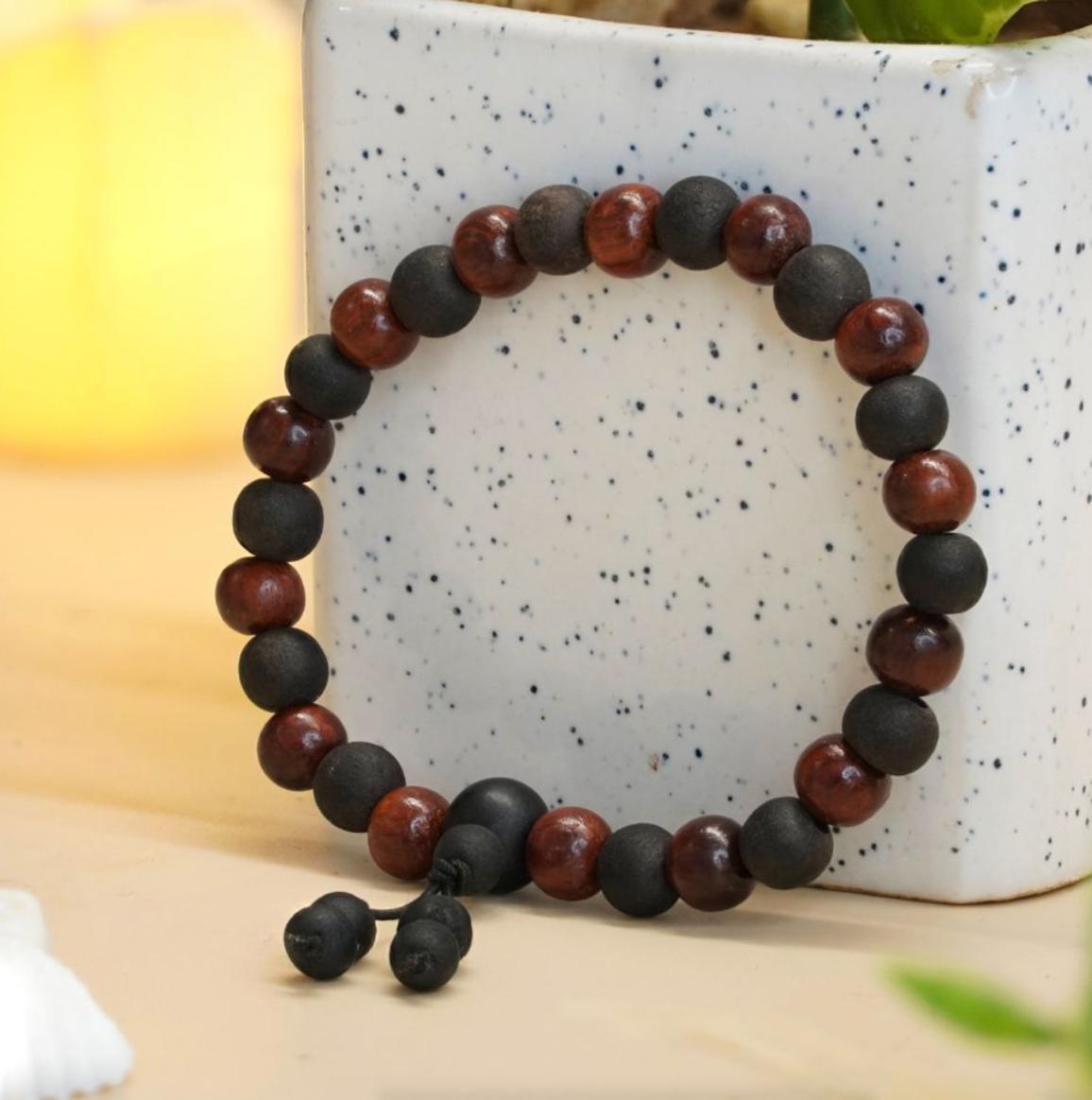 Sandalwood and Karungali Beads bracelet on a speckled ceramic surface