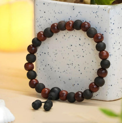 Sandalwood and Karungali Beads bracelet on a speckled ceramic surface