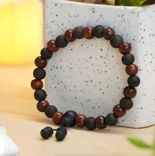 Sandalwood and Karungali Beads bracelet on a speckled ceramic surface