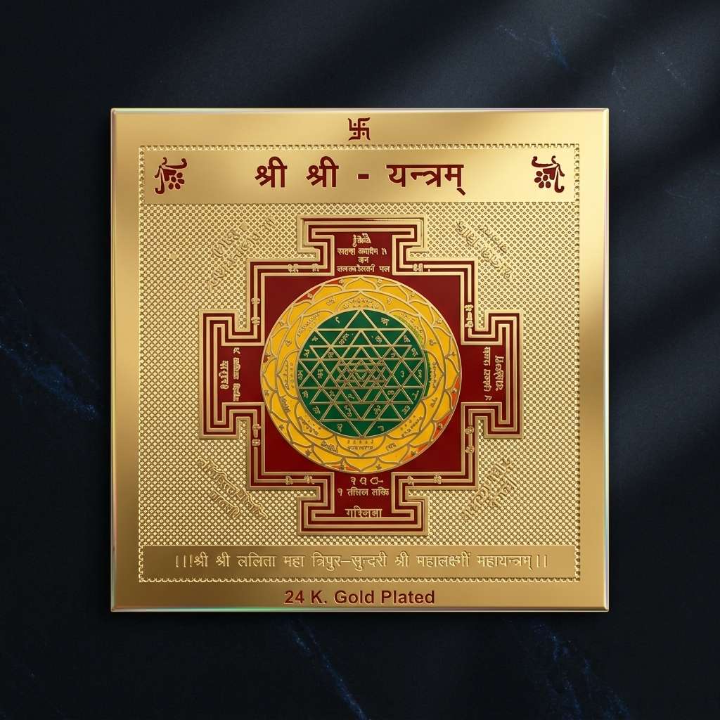 Gold-plated Yantra with intricate design on a dark background